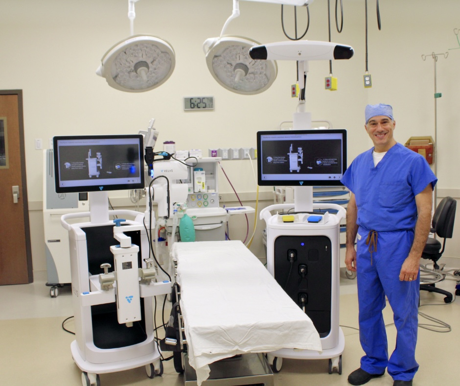 Dr. Hatten in the operating room with the VELYS robotic-assisted surgical system for knee replacement surgery